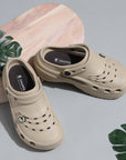 Dynamic top view of beige clogs showing breathable design