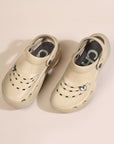 Beige EVA clogs with ventilation holes, thick outsole, and heel strap