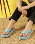 Close of girl's feet wearing sky blue casual flip-flops by Chupps