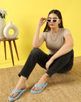 Girl wearing sky blue casual flip-flops by Chupps