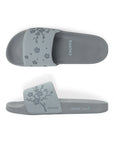 Close-up of traction outsole on grey sliders for steady steps.