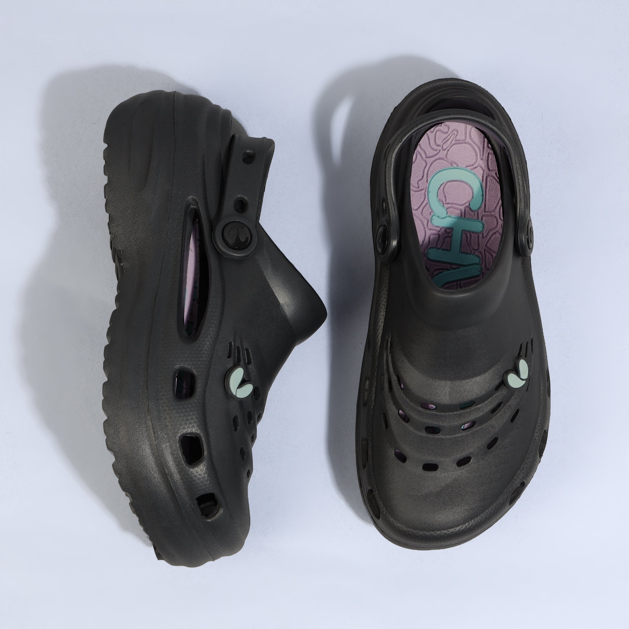Black sandel with a visible brand logo inside 