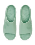 POV Top shot of pista green chupster with dot pattern on a white background