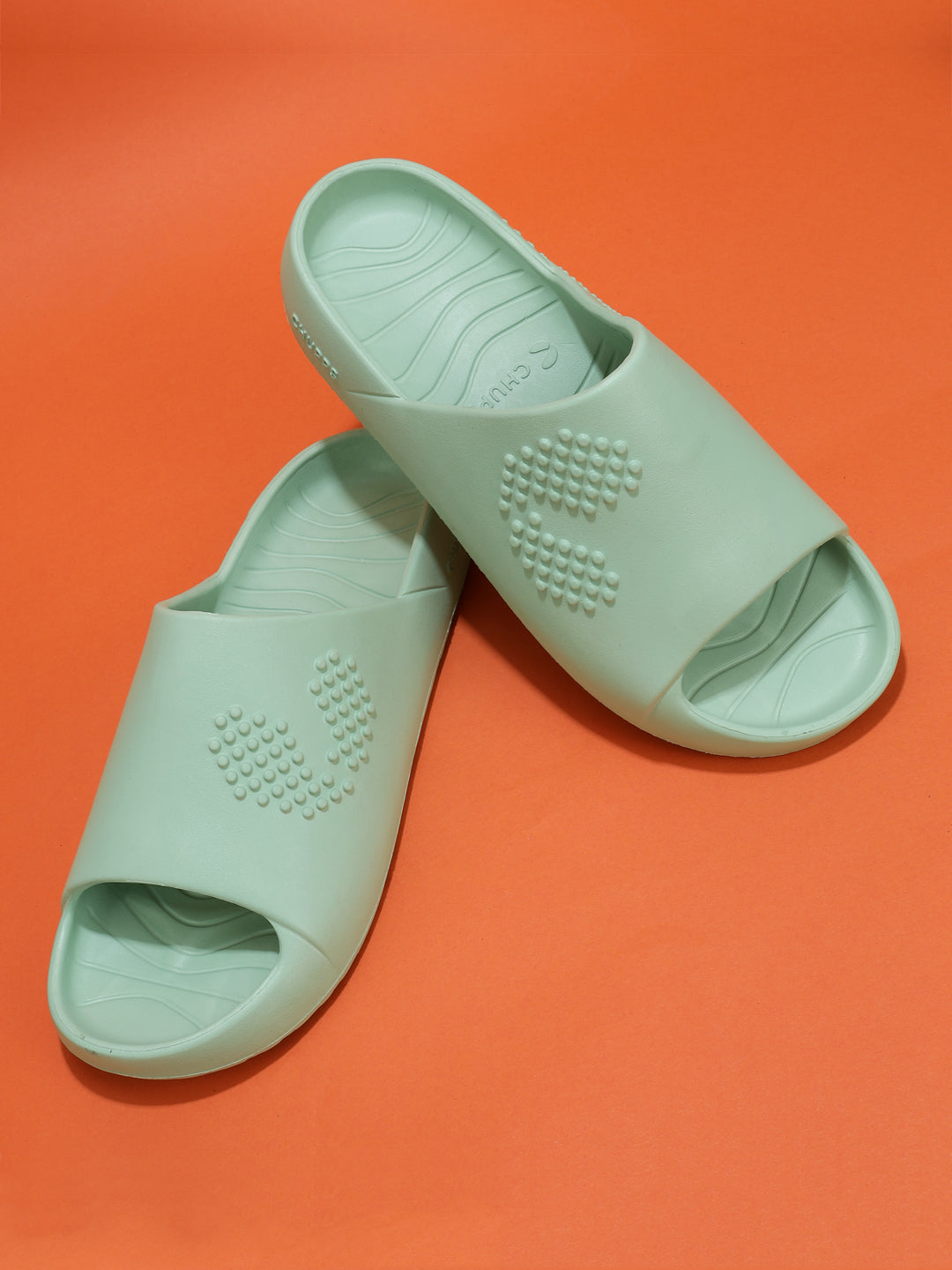 Pair of Pista green Chupster resting on each other on an orange background