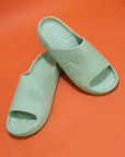 Pair of Pista green Chupster resting on each other on an orange background