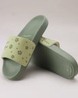Dynamic view of Pista Green sliders highlighting slim strap and minimal profile.
