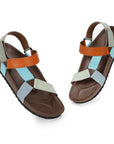 Pair of sandals with brown, orange, and multicolor straps on a white background