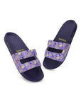 Pair of purple slides with floral straps on a white background