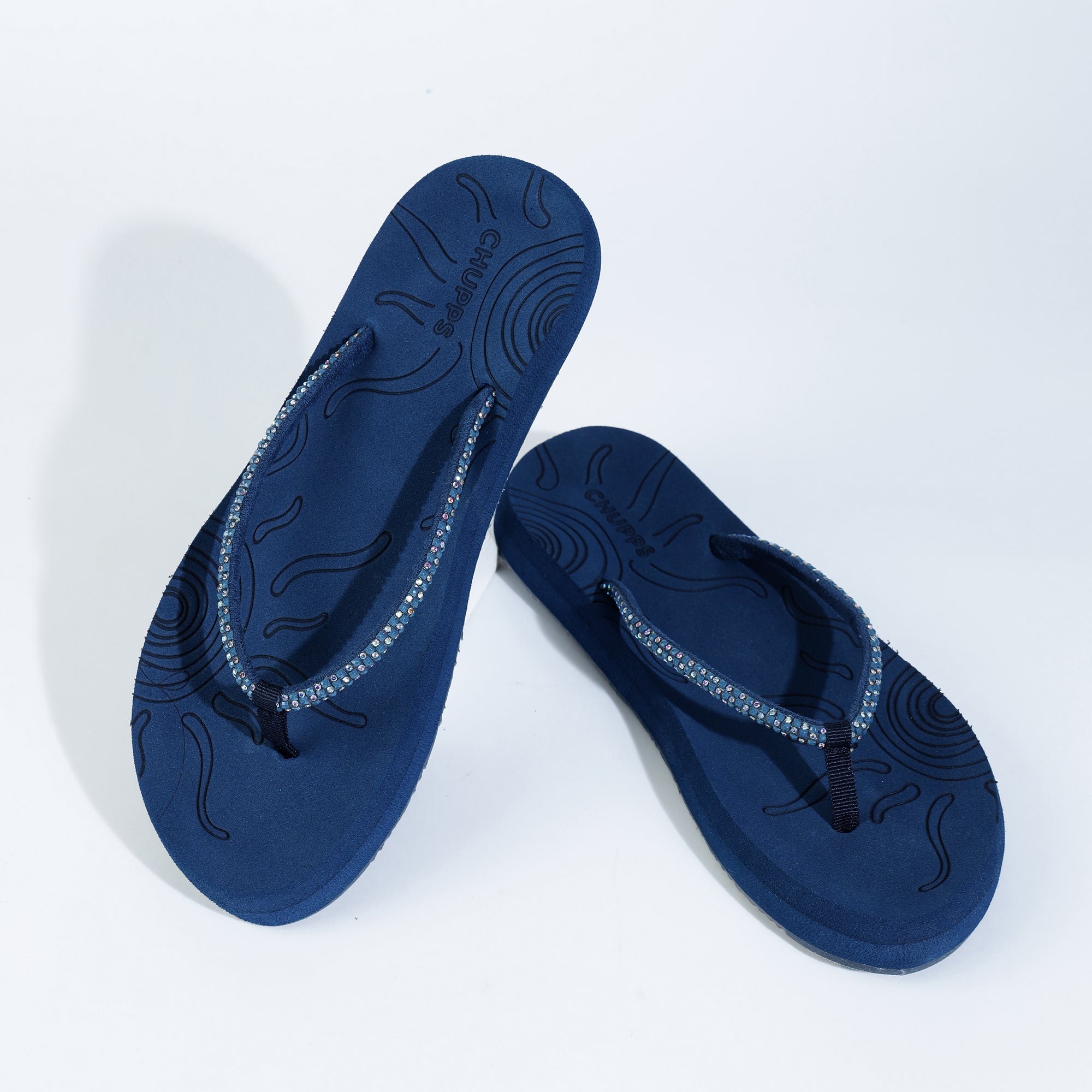 Navy blue flip-flops placed on a white background