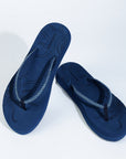 Navy blue flip-flops placed on a white background
