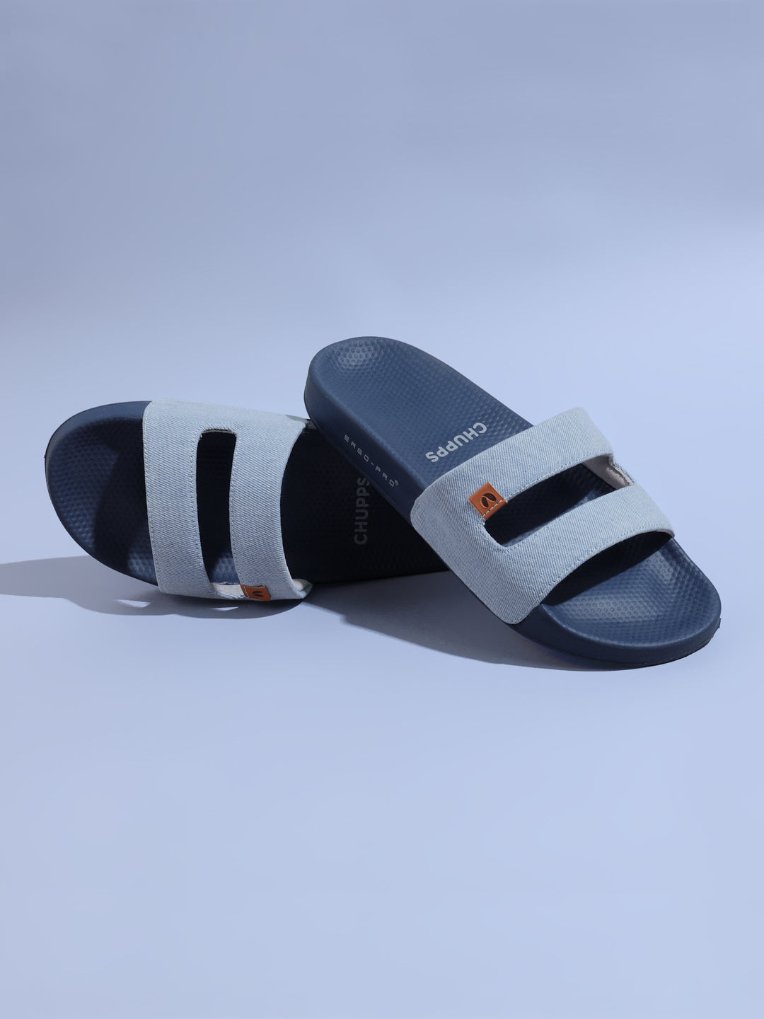 Chupps Zella Sky Blue Denim Sliders with sky blue denim strap and central cut-out. On a light blue background