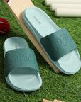 Lime green sliders for men with cushioned AirSoft Sole on a dark green background