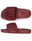 Red slide sandals with ruched design on a white background
