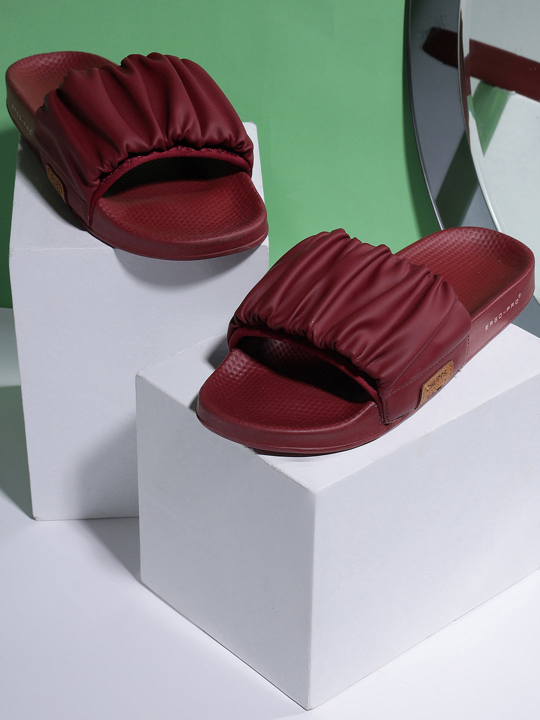 Maroon slides on a white block with a green background
